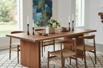 A modern, space-saving 30 inch wide dining table, crafted from light wood and paired with two chairs, ideal for small apartments and compact dining areas.