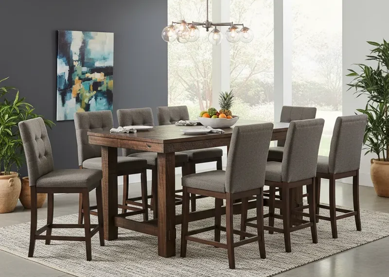 A modern 9 piece counter height dining set featuring a large rectangular table and eight matching chairs, perfect for a spacious kitchen or dining room. The set provides elevated seating for comfortable meals and entertaining.