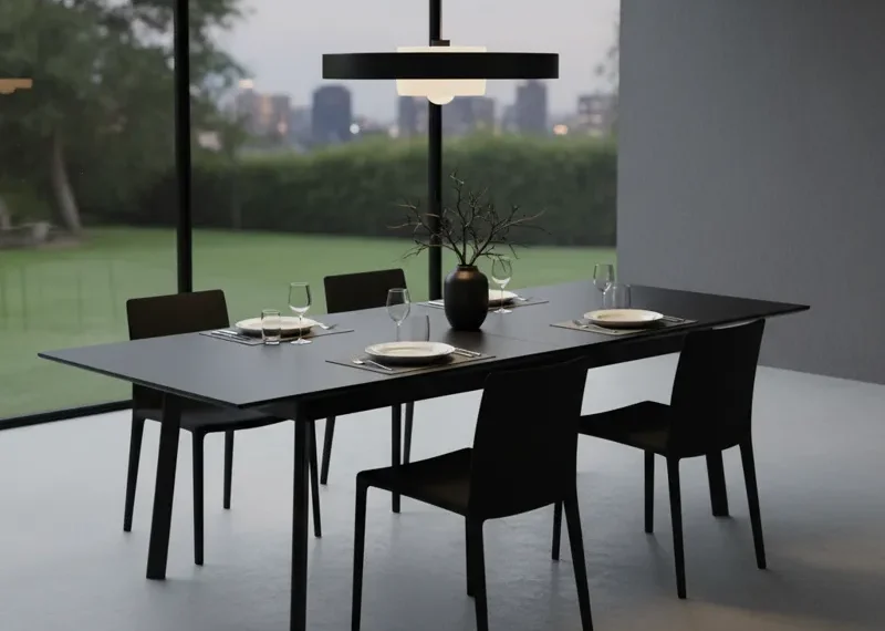Sleek black extendable dining table, shown in its compact form, with a smooth matte finish, ideal for modern kitchens or dining rooms.