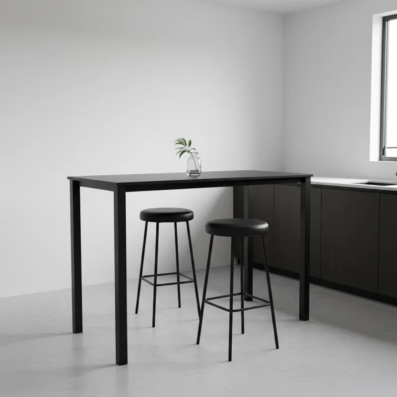A sleek, modern black high top kitchen table with two matching black bar stools in a minimalist kitchen setting. The table has a matte finish, and the