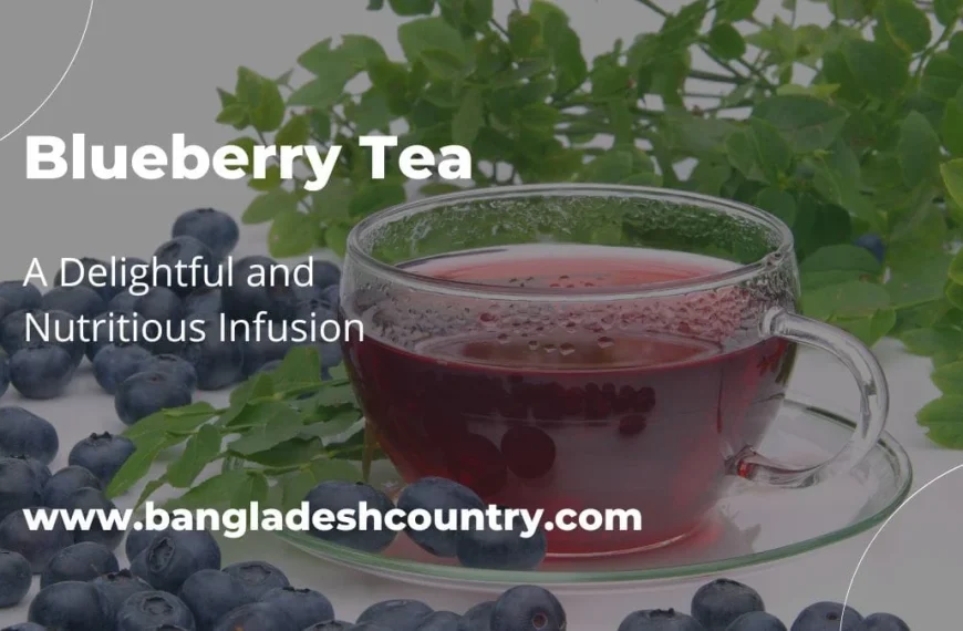 A clear glass cup of red blueberry tea sits on a saucer, surrounded by fresh blueberries and the green leaves of a blueberry plant.