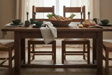 Dark farmhouse dining table made from reclaimed, distressed solid wood, featuring a rustic finish ideal for a vintage-inspired kitchen or dining room.