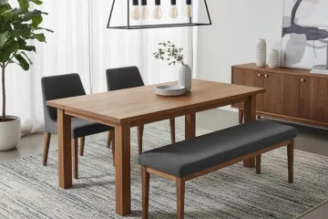 Modern gray dining room set with a rectangular table, a long matching bench on one side, and two individual upholstered chairs on the opposite side, designed for family dining.