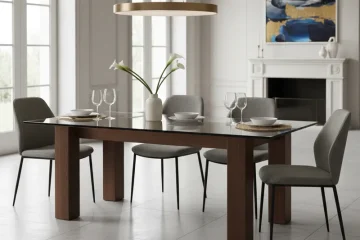 Modern dining table featuring a sleek, transparent glass top supported by a sturdy, natural wood base, showcasing a blend of contemporary and classic materials.