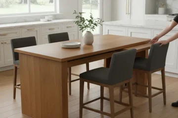 A modern expandable counter height table made of light wood, shown in both its compact and extended forms. The table features a built-in leaf mechanism and comfortably seats 2-6 people, ideal for flexible kitchen and dining spaces.