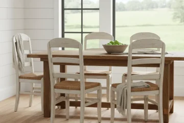 Set of four natural solid wood farmhouse dining chairs with a simple, sturdy design, suitable for rustic or country-style dining rooms. The chairs feature spindle backs and turned legs.