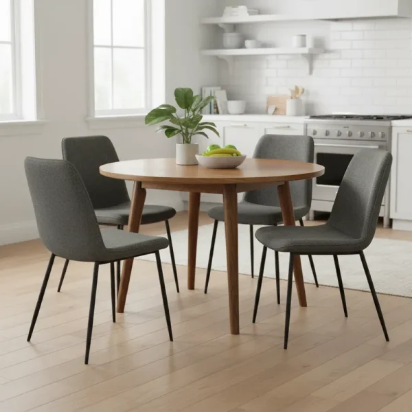 Modern gray upholstered kitchen table chairs with wooden legs around a light wood dining table in a bright kitchen.
