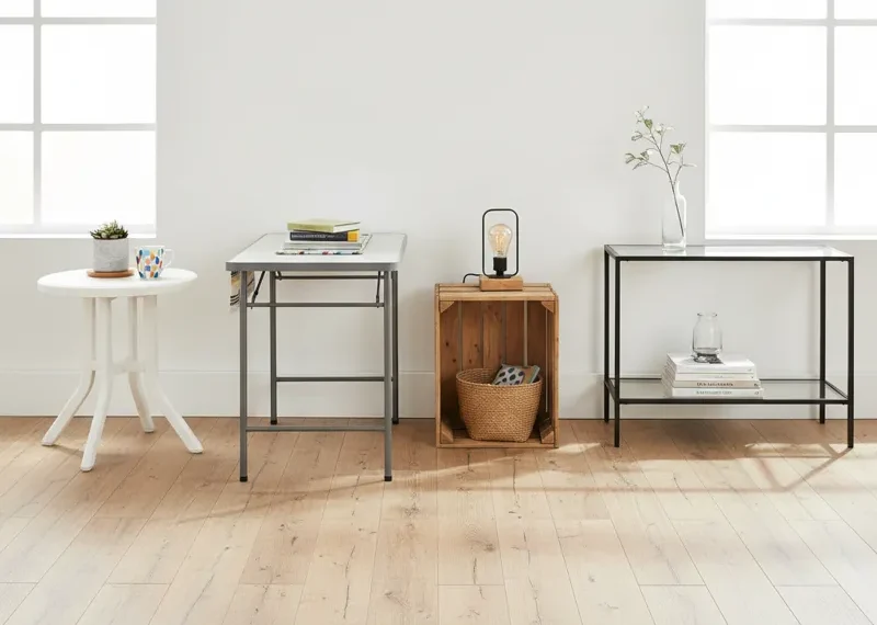 A modern, minimalist white coffee table, representing an inexpensive and affordable furniture option for living rooms.