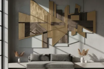 Large abstract modern wall art in black and white hues above a sleek gray sofa in a contemporary living room, featuring minimalist decor and a high ceiling.