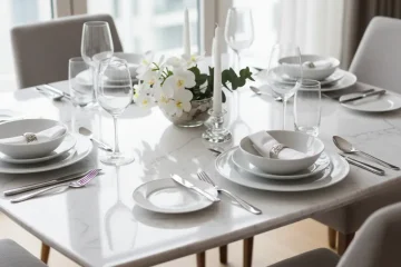 A luxurious white marble dining table set for 4, featuring a sleek rectangular marble top and four comfortable, modern dining chairs, placed in a contemporary dining room.