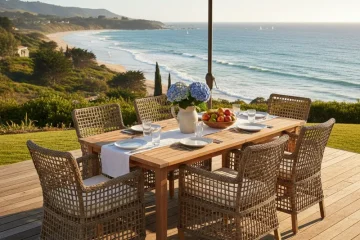 Modern outdoor dining set with a rectangular table and six chairs, featuring comfortable cushions, placed on a patio ready for al fresco meals.