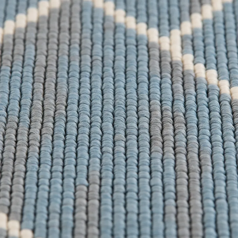 Close-up of polypropylene rug fibers, showing their synthetic, uniform texture and tight weave.