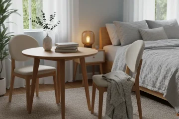 A small, elegant wooden dressing table with two matching upholstered chairs, positioned in a compact bedroom setting. Ideal for a vanity or workspace.