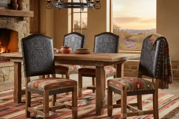 Rustic western dining chairs with dark brown leather upholstery, nailhead trim, and sturdy wooden frames, ideal for farmhouse or ranch-style dining rooms.