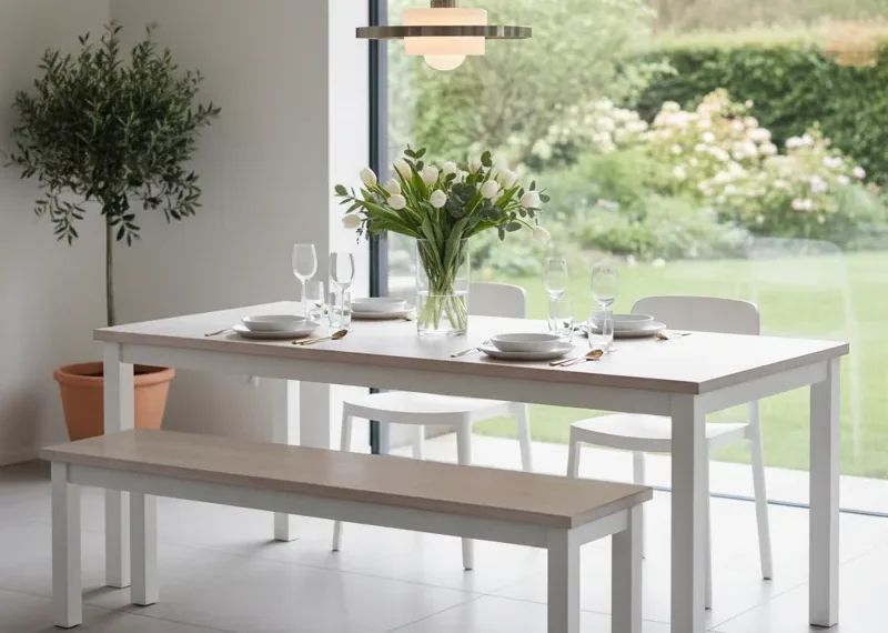 White modern dining table paired with a matching white dining bench, set in a clean, minimalist dining room or kitchen.